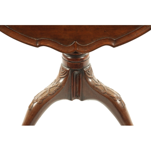 304 - AN 18TH CENTURY FIGURED MAHOGANY PIE CRUST TRIPOD TABLE ON MANX FEET with a turned stem and ribbon c... 