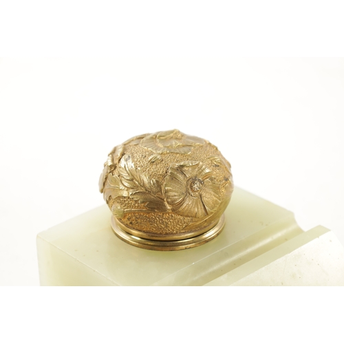 311 - AN EDWARDIAN ONYX AND ORMOLU MOUNTED INKWELL with floral decorated top (16.5cm deep 11cm wide 12cm h... 