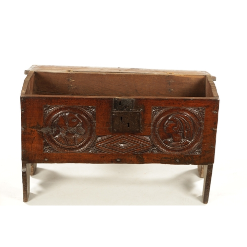 316 - AN IMPORTANT 17TH CENTURY CARVED OAK PLANK COFFER WITH CARVED ROMANESQUE HEADS with hinged top havin... 