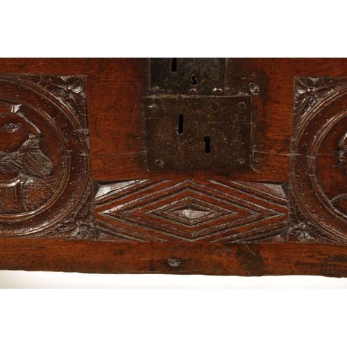 316 - AN IMPORTANT 17TH CENTURY CARVED OAK PLANK COFFER WITH CARVED ROMANESQUE HEADS with hinged top havin... 