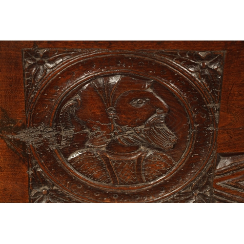 316 - AN IMPORTANT 17TH CENTURY CARVED OAK PLANK COFFER WITH CARVED ROMANESQUE HEADS with hinged top havin... 