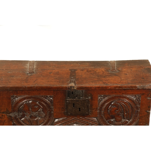 316 - AN IMPORTANT 17TH CENTURY CARVED OAK PLANK COFFER WITH CARVED ROMANESQUE HEADS with hinged top havin... 