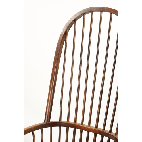 327 - A 19TH CENTURY PRIMITIVE PAINTED STICK BACK WINDSOR ARMCHAIR having an unusual high back raised on r... 