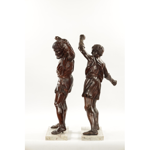 337 - A PAIR OF GRAND TOUR CARVED WALNUT GLADIATORS AFTER THE BORGHESE BRONZE ROMAN FIGURES mounted on mar... 