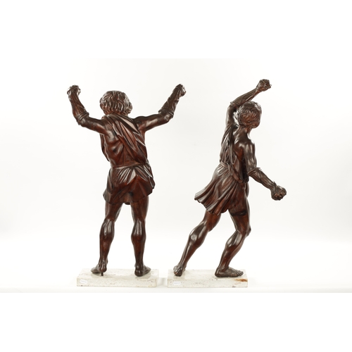 337 - A PAIR OF GRAND TOUR CARVED WALNUT GLADIATORS AFTER THE BORGHESE BRONZE ROMAN FIGURES mounted on mar... 