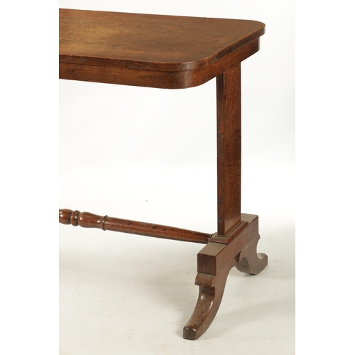 340 - A REGENCY FIGURED OAK COUNTRY HOUSE LIBRARY TABLE with end supports joined by cross stretcher; raise... 