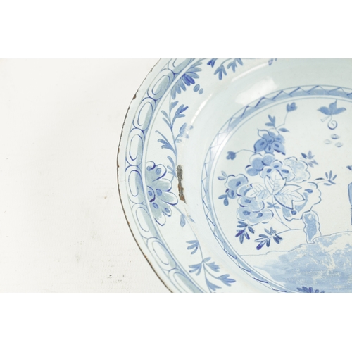 341 - AN 18TH CENTURY TINWARE BLUE AND WHITE DELFT STYLE PLATE with oriental figure and flowering trees (2... 