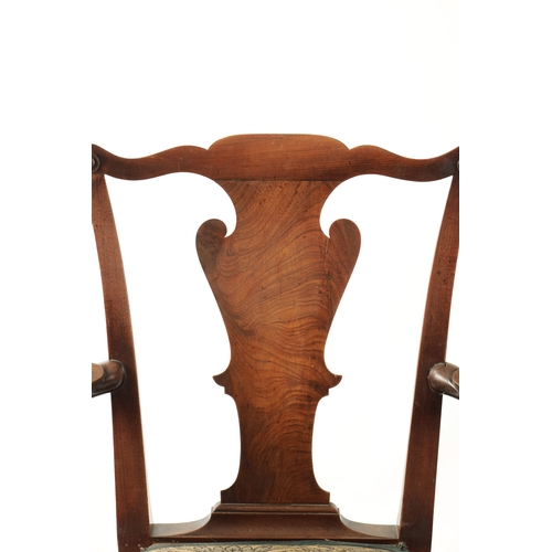 352 - AN 18TH CENTURY FIGURED MAHOGANY COMMODE CHAIR with shaped back splats scrolled arms and short cabri... 