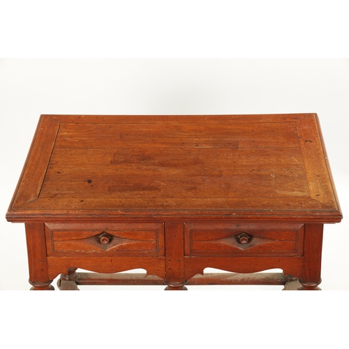 353 - AN UNUSUAL 18TH CENTURY COLONIAL PADOUK WOOD TWO DRAWER TABLE on turned cup and cover legs. (84cm wi... 