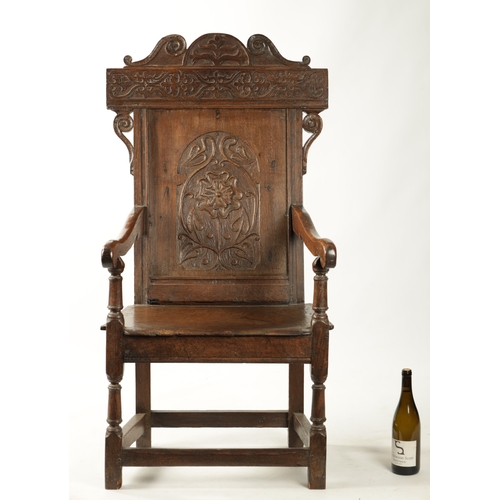 357 - A 17TH CENTURY WAINSCOT CHAIR WITH TUDOR ROSE with shaped carved top rail, plank seat and turned sup... 