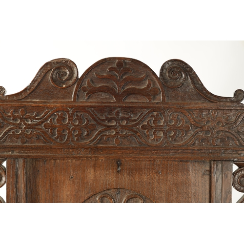 357 - A 17TH CENTURY WAINSCOT CHAIR WITH TUDOR ROSE with shaped carved top rail, plank seat and turned sup... 