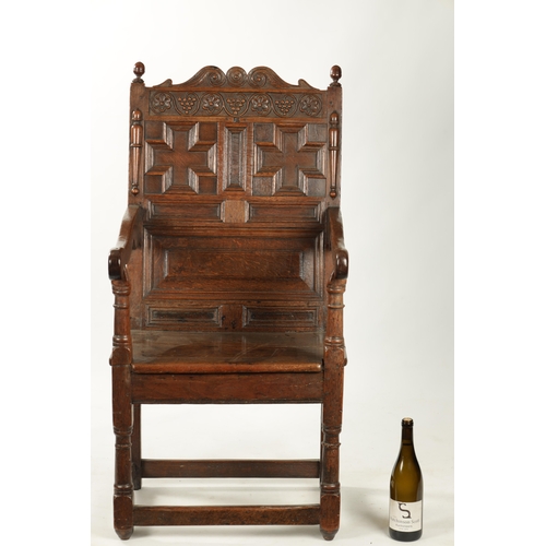 360 - A 17TH CENTURY CARVED OAK JACOBEAN STYLE WAINSCOT CHAIR with grape and floral top rail (56cm wide 11... 