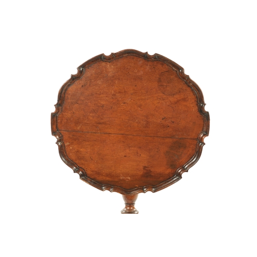 37 - AN 18TH CENTURY COUNTRY MADE MAHOGANY TILT TOP TRIPOD TABLE having a pie crust top with vase shaped ... 