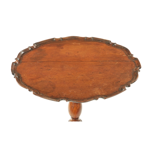 37 - AN 18TH CENTURY COUNTRY MADE MAHOGANY TILT TOP TRIPOD TABLE having a pie crust top with vase shaped ... 