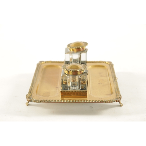 371 - A 19TH CENTURY BRASS DESKTOP INKWELL with two glass inkwells and recessed pen trays (27cm wide 19cm ... 