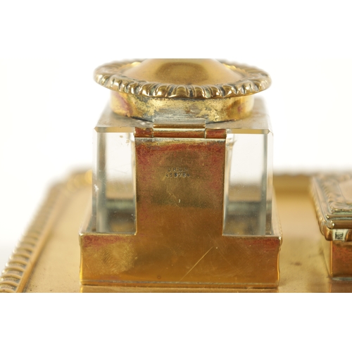 371 - A 19TH CENTURY BRASS DESKTOP INKWELL with two glass inkwells and recessed pen trays (27cm wide 19cm ... 