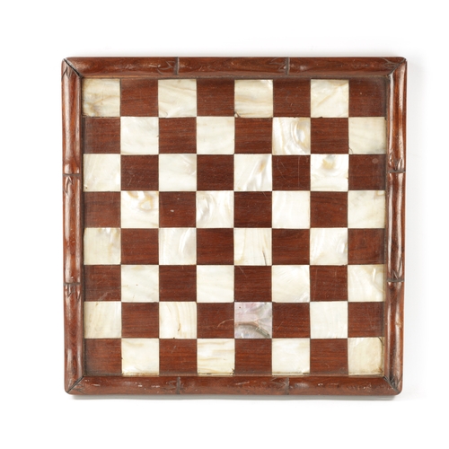 373 - A 19TH CENTURY CHINESE SIMULATED BAMBOO CARVED HARDWOOD AND MOTHER OF PEARL CHEQUERED GAMES BOARD