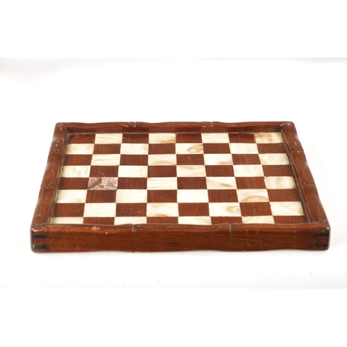 373 - A 19TH CENTURY CHINESE SIMULATED BAMBOO CARVED HARDWOOD AND MOTHER OF PEARL CHEQUERED GAMES BOARD