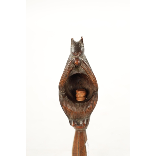 383 - A 19TH CNEUTRY CARVED FRUITWOOD TREEN NUTCRACKER modelled as a squirrel (16cm overall)