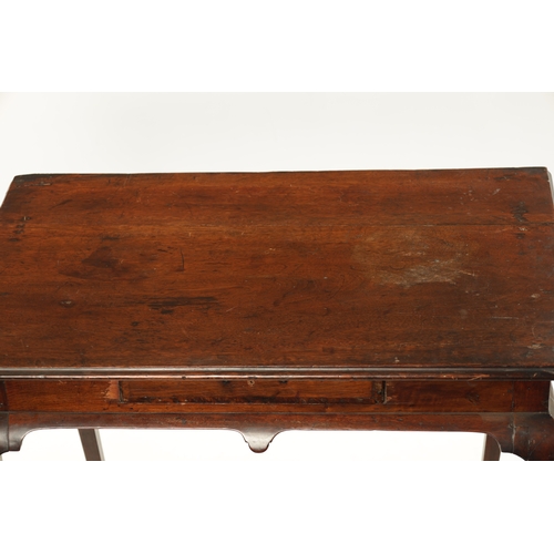 410 - A GEORGE I WALNUT SILVER TABLE with shallow frieze drawer, fitted candle slides and raised on cabrio... 