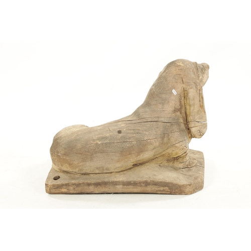 413 - A 19TH CENTURY CARVED WOOD SCULPTURE OF A SEATED DOG inscribed on base 'Henri' (73cm wide 45cm deep ... 