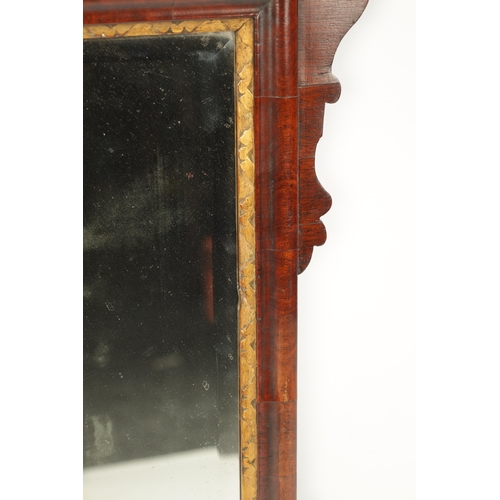 424 - A SMALL 18TH CENTURY WALNUT HANGING MIRROR with gilt shell pediment and shaped surround (80cm high 4... 