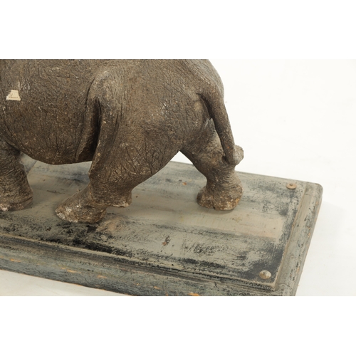 425 - AN UNUSUAL CARVED STONE / MARBLE SCULPTURE OF A RHINO on a hardwood base. (84cm wide 30cm deep 37cm ... 