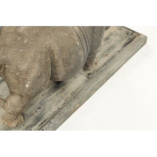 425 - AN UNUSUAL CARVED STONE / MARBLE SCULPTURE OF A RHINO on a hardwood base. (84cm wide 30cm deep 37cm ... 