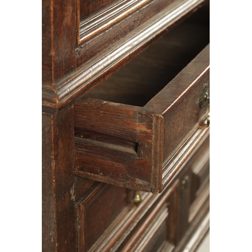 428 - AN UNUSUAL 17TH CENTURY JACOBEAN MOULDED FRONT OAK CHEST OF DRAWERS with hinged top above three moul... 