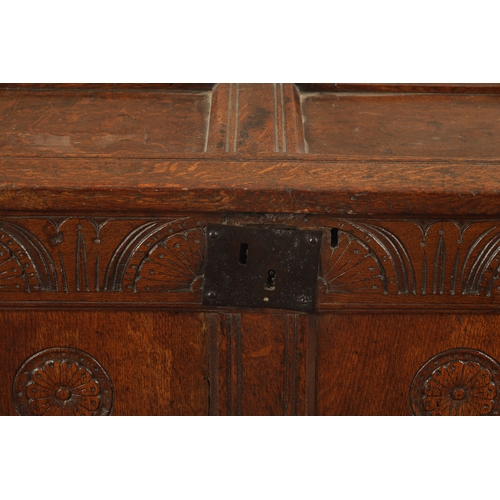 43 - A SMALL 17TH CENTURY OAK TWO PANEL COFFER with carved top rail and raised on stile feet (95cm wide 4... 