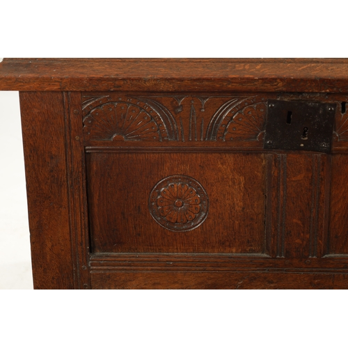 43 - A SMALL 17TH CENTURY OAK TWO PANEL COFFER with carved top rail and raised on stile feet (95cm wide 4... 