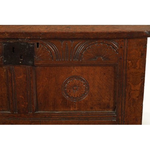 43 - A SMALL 17TH CENTURY OAK TWO PANEL COFFER with carved top rail and raised on stile feet (95cm wide 4... 