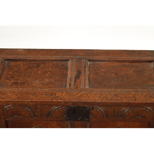 43 - A SMALL 17TH CENTURY OAK TWO PANEL COFFER with carved top rail and raised on stile feet (95cm wide 4... 