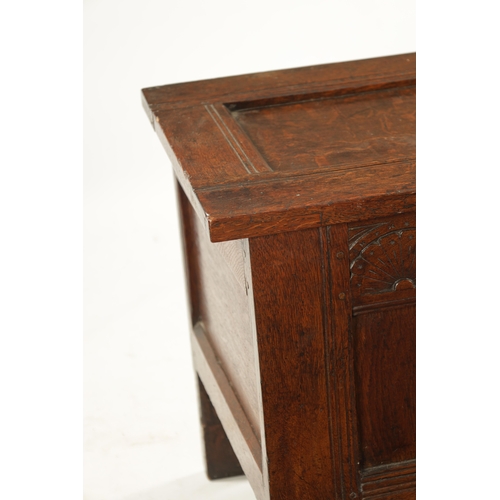 43 - A SMALL 17TH CENTURY OAK TWO PANEL COFFER with carved top rail and raised on stile feet (95cm wide 4... 