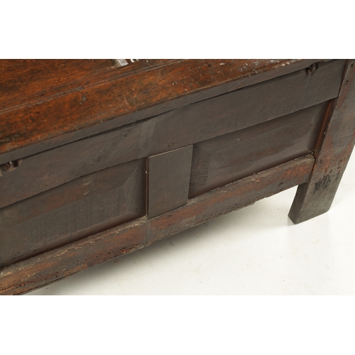 43 - A SMALL 17TH CENTURY OAK TWO PANEL COFFER with carved top rail and raised on stile feet (95cm wide 4... 