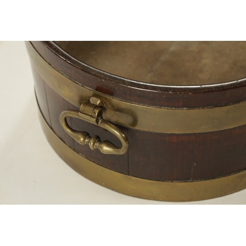 44 - A GEORGE III OVAL BRASS BOUND MAHOGANY WINE COOLER with fitted side handles (64cm wide 44cm deep 20c... 