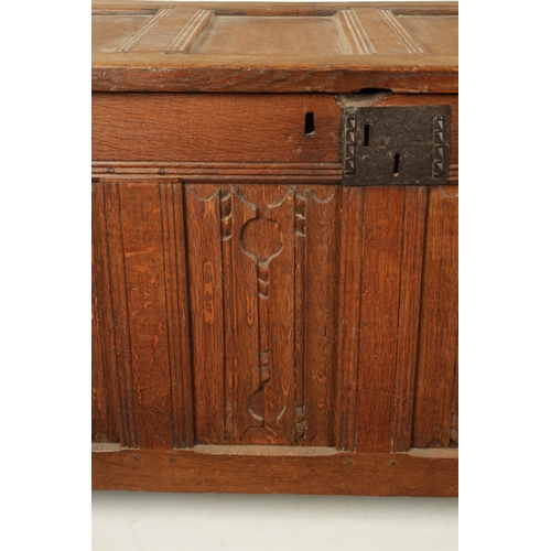 444 - A 17TH CENTURY CARVED OAK LINEN FOLD COFFER with four panel top and iron lock plate; raised on stile... 