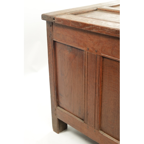 444 - A 17TH CENTURY CARVED OAK LINEN FOLD COFFER with four panel top and iron lock plate; raised on stile... 