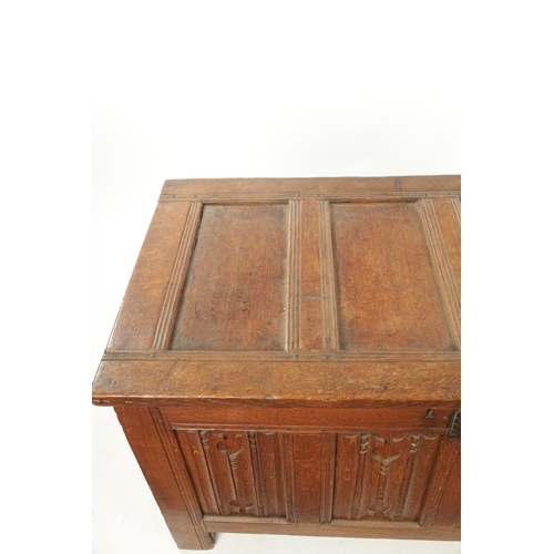 444 - A 17TH CENTURY CARVED OAK LINEN FOLD COFFER with four panel top and iron lock plate; raised on stile... 