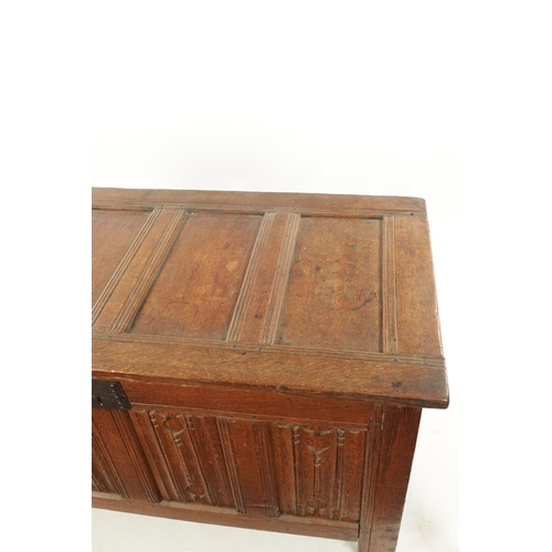 444 - A 17TH CENTURY CARVED OAK LINEN FOLD COFFER with four panel top and iron lock plate; raised on stile... 