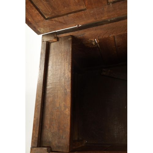 444 - A 17TH CENTURY CARVED OAK LINEN FOLD COFFER with four panel top and iron lock plate; raised on stile... 