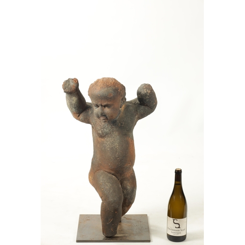 445 - AN EARLY 18TH CENTURY TERRACOTTA FIGURE OF STANDING CHERUB mounted on a later iron stand