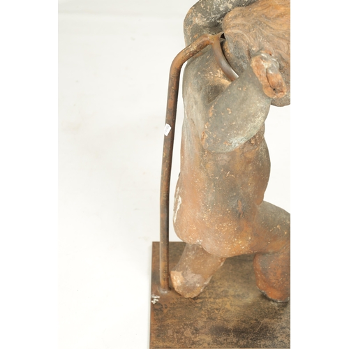 445 - AN EARLY 18TH CENTURY TERRACOTTA FIGURE OF STANDING CHERUB mounted on a later iron stand