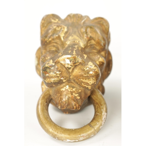 46 - A SET OF FOUR REGENCY CARVED GILTWOOD LION'S HEADS three with looped handles. (10.5cm wide)