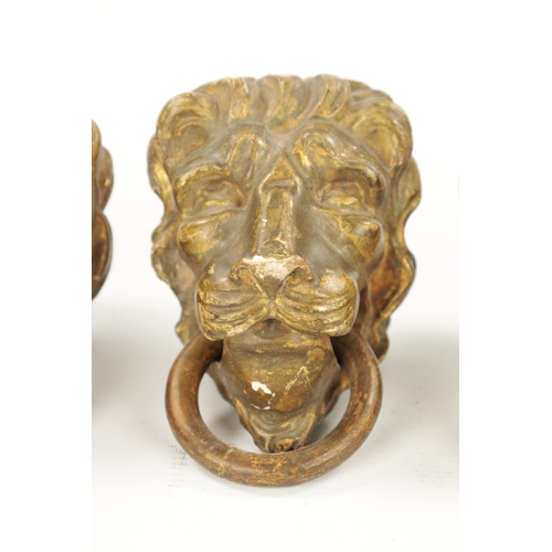 46 - A SET OF FOUR REGENCY CARVED GILTWOOD LION'S HEADS three with looped handles. (10.5cm wide)