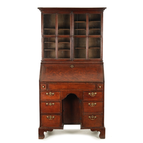 5 - AN UNUSUAL QUEEN ANNE OAK KNEEHOLE BUREAU BOOKCASE with glazed top section above an angled fall with... 