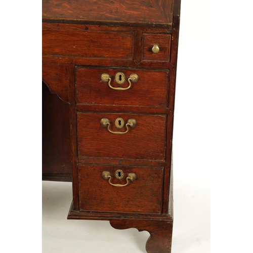 5 - AN UNUSUAL QUEEN ANNE OAK KNEEHOLE BUREAU BOOKCASE with glazed top section above an angled fall with... 