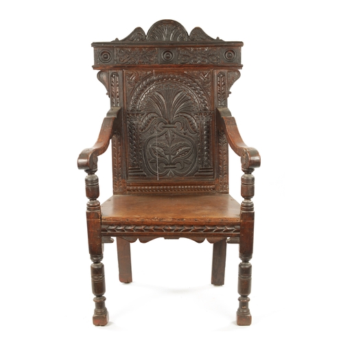 55 - A 17TH CENTURY CARVED OAK WAINSCOT CHAIR having leaf carved back and plank seat; open arms and turne... 