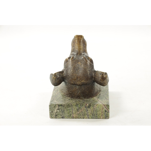 56 - A 20TH CENTURY BRONZE SCULPTURE OF A DOG'S HEAD mounted on a hanging marble back (21cm high 15.5cm w... 