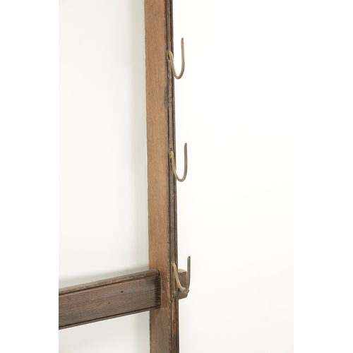 57 - AN 18THN CENTURY OAK WALL HANGING WHIP RACK (154cm high 82cm wide)